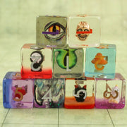 Stack of transparent blocks with various designs and numbers on a light background