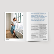 Magazine layout with a woman standing by a window and text on a white background